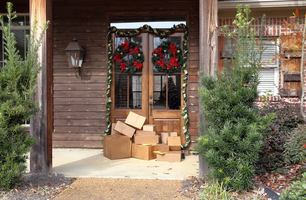 Boxes and packages next to front door during holiday christmas season.