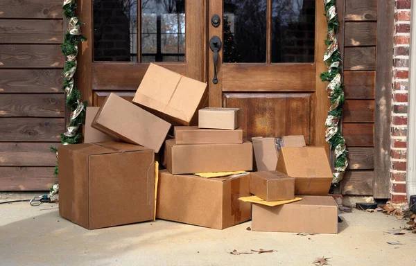 Boxes and packages next to front door during holiday christmas season.