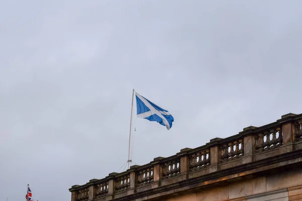 Scotland flag on of historic building at street in Edinburgh, Scotland, United Kingdom