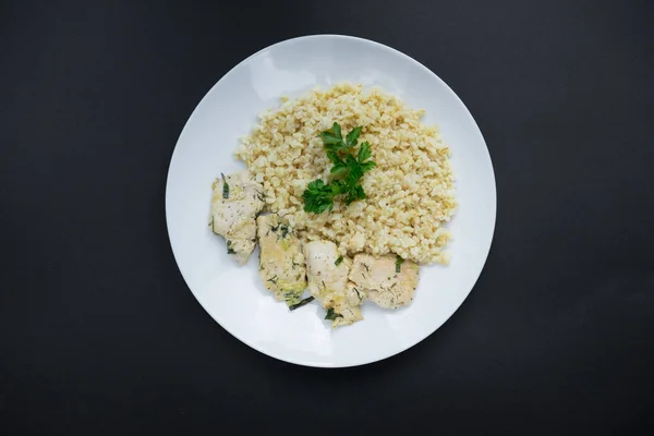 Bulgur with meat on a black background — Stock Photo, Image