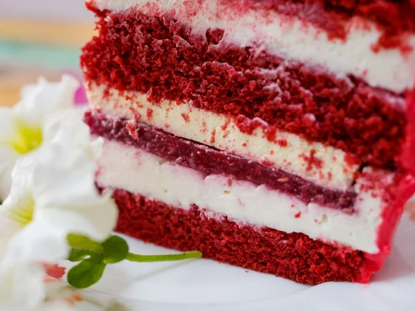 A piece of red cake on a plate close-up