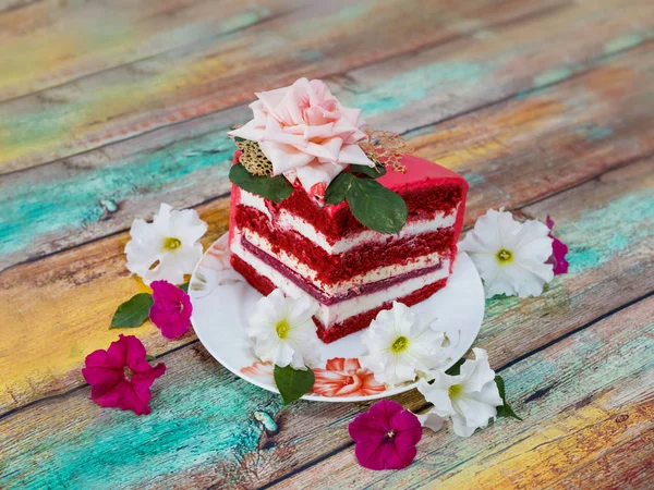 A piece of festive cake on a wooden background — Stock Photo, Image