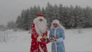 Joyful and happy Santa have fun in a pine forest on a winter day