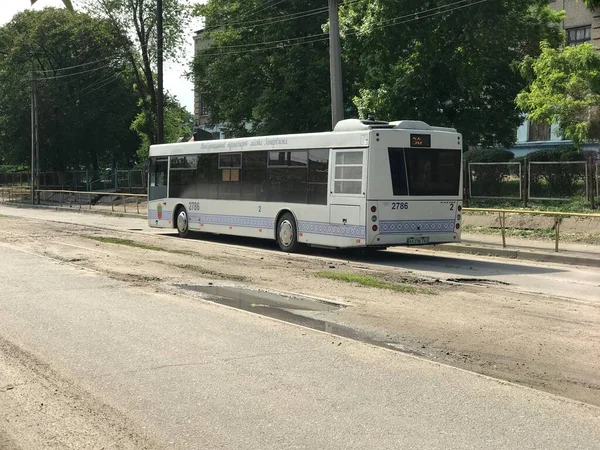 Bus Rides Dusty Muddy Street Road Small Town Illuminated Bright — Stock Photo, Image