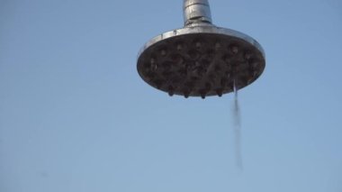 Su damlaları yavaşça şehir plajından açık gökyüzüne akıyor.
