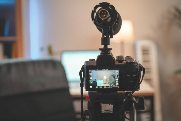 Behind the scenes at home shooting set with camera and lightning setting. Influencer's amazing work space. Ready to start filming.