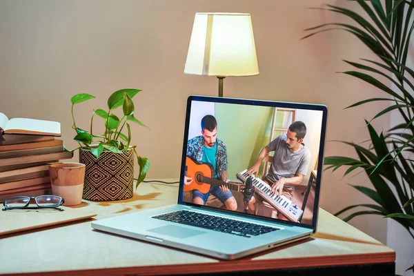 Coronavirus concept. Back view of man watching live concert video while staying at home. Close up of a man enjoying a musical concert on a laptop. Stay at home. Quarantine. Isolated.