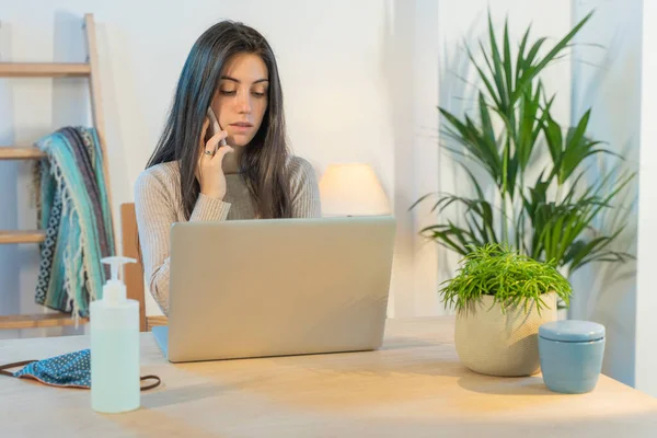 Business woman working at home with computer. Small company working and doing business. Home working during quarantine concept. Little office. Coronavirus. Sanitizer gel.