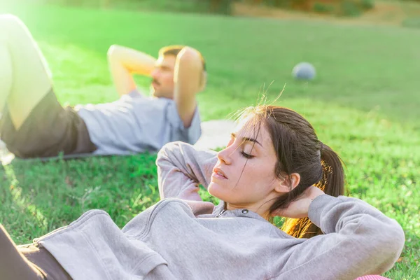 Young Couple Doing Exercise Morning Garden Sunlight Doing Ads Wearing — Stock Photo, Image