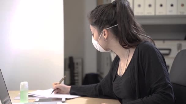 コロナウイルス 保護マスクを着用して自宅から働く企業の労働者 サニタイザージェルで自宅から働くコロナウイルスの隔離の小さな会社 小企業のコンセプト — ストック動画