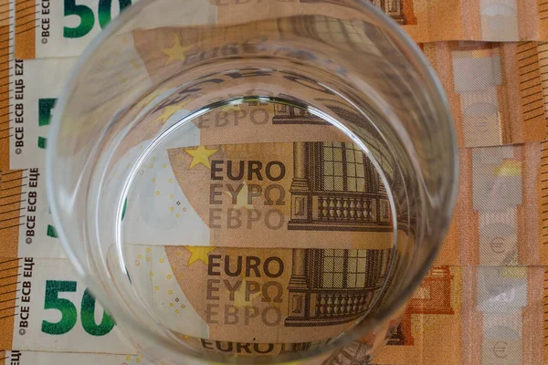 50 avroluk banknotların üstüne bir bardak su, ekonomi konsepti.