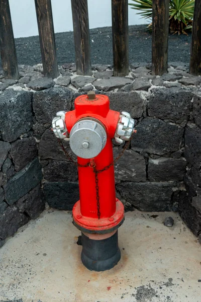 Old red fire hose connector on the sidewalk, Lanzarote Island, Canary Islands Spain