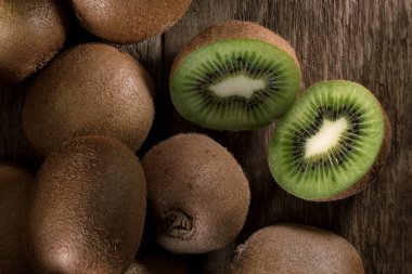 Fresh biologic Kiwi fruit on a wooden table. clipart