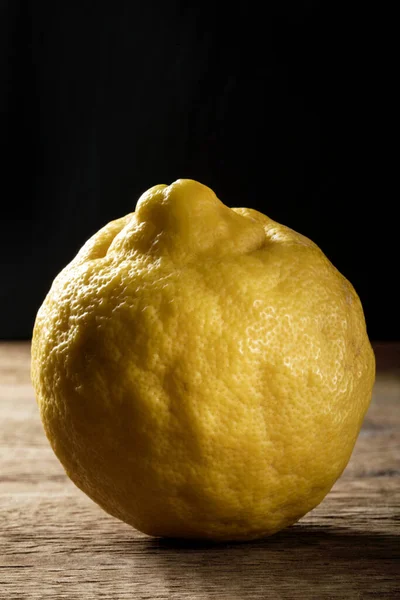 Fresh biologic lemon on a wooden table.