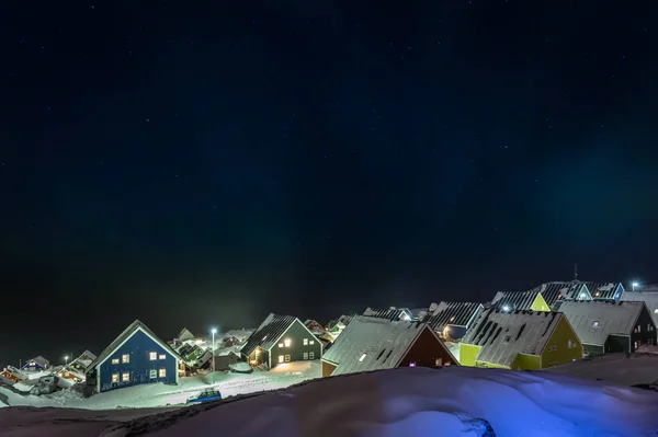 Arctic polar night over colorful inuit houses in a suburb of arctic capital Nuuk, Greenland