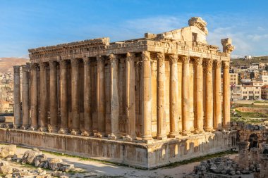 Columns of ancient Roman temple of Bacchus with surrounding ruin clipart