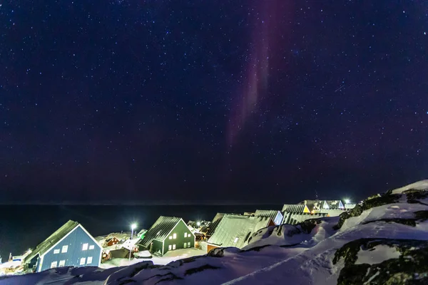 Арктическая полярная ночь над красочными инуитскими домами с небольшим северным покровом — стоковое фото
