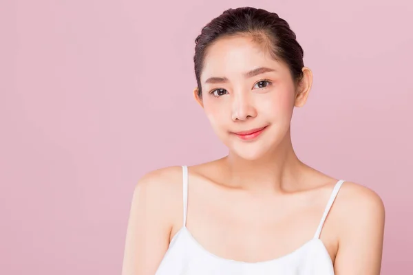 Young beauty healthy happy Asian woman with smiley face isolated on pink background.