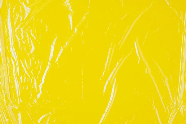 Textura Celofán Transparente Sobre Respaldo Amarillo — Foto de Stock