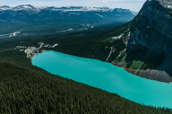 Breathtaking view of the turquoise lake, world famous Fairmont Hotel and mountain scenery from the summit of The Big Beehive hiking trail above Lake Louise, Banff National Park, Alberta, Canada