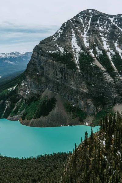 Breathtaking view of the turquoise lake, world famous Fairmont Hotel and mountain scenery from the summit of The Big Beehive hiking trail above Lake Louise, Banff National Park, Alberta, Canada