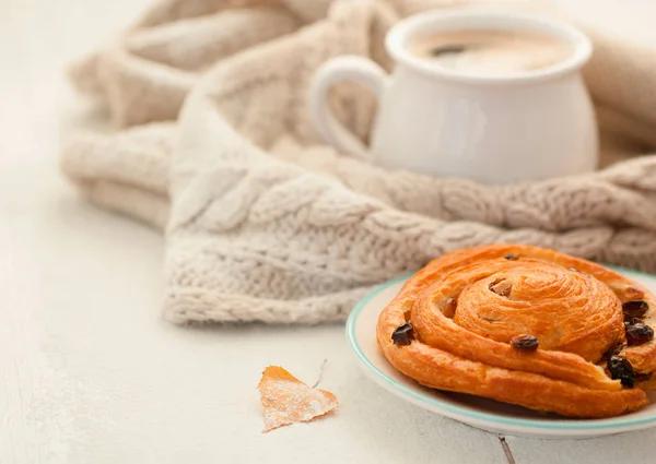 First snow. Cozy breakfast on the veranda: coffee and cinnamon and raisin bun