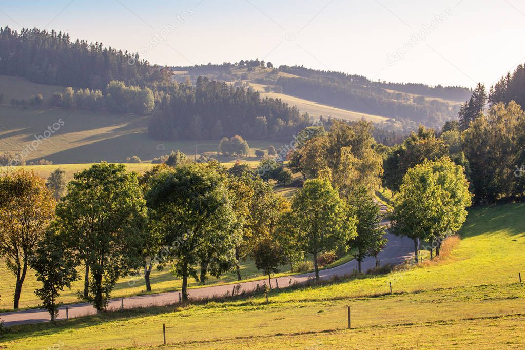 Zdarske Vrchy, Czech Republic, rural landscape with road at suns