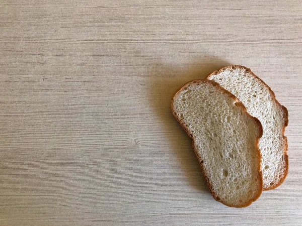 Two pieces of white bread on a light background — Stock Photo, Image