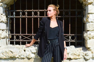 Bir iş siyah takım elbise seksi bir genç kadın duruyor