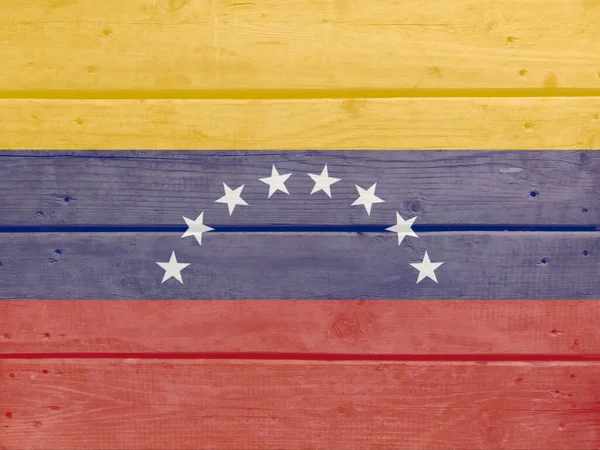 Venezuela flag painted on wood plank background. Brushed natural light knotted wooden board texture. Wooden texture background flag of Venezuela