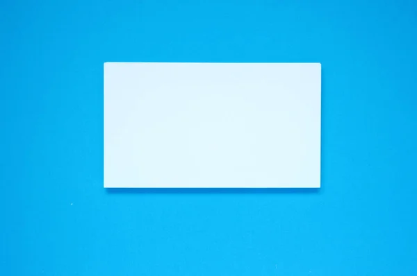 White blank paper on a blue background.