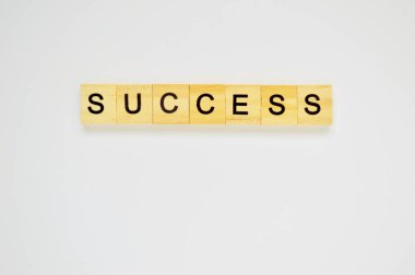 Kelime başarısı. Beyaz arka planda harfleri olan tahta bloklar. Beyaz yüzeyde harfleri olan tahta blokların üst görünümü