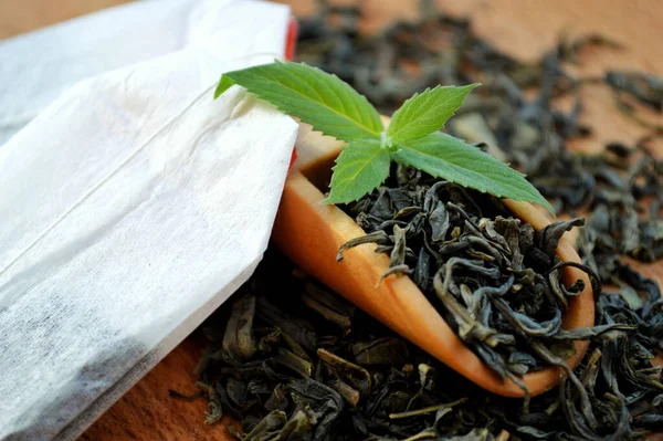 Tea Bags Wooden Spoon Fresh Mint Leaves Lie Heap Tea — Stock Photo, Image