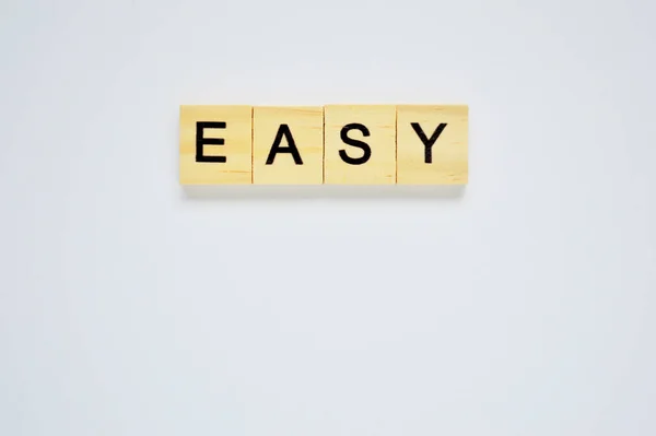 Word Easy Wooden Blocks Lettering Top White Background Top View — Stock Photo, Image