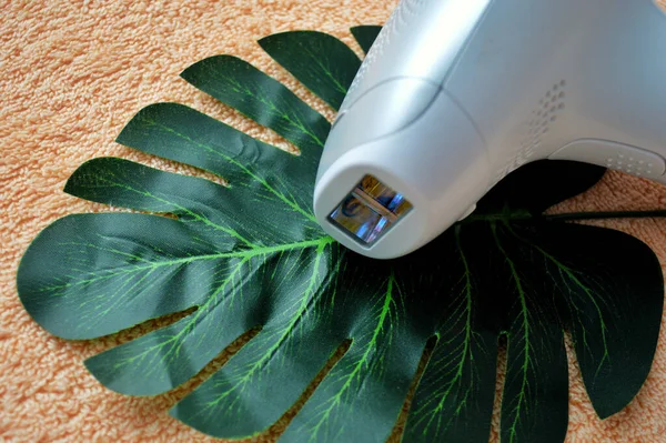 Photoepilator Lies Palm Leaf Background Beige Fabric — Stock Photo, Image
