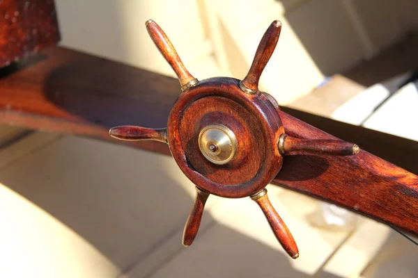 Close-up of the steering wheel of the ship as a decoration. The ship\'s wheel is on the deck.