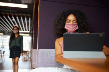 Sağlık Salgını sırasında Ofiste Sosyal Mesafeli Kabinde Maske Giyen İş Kadını