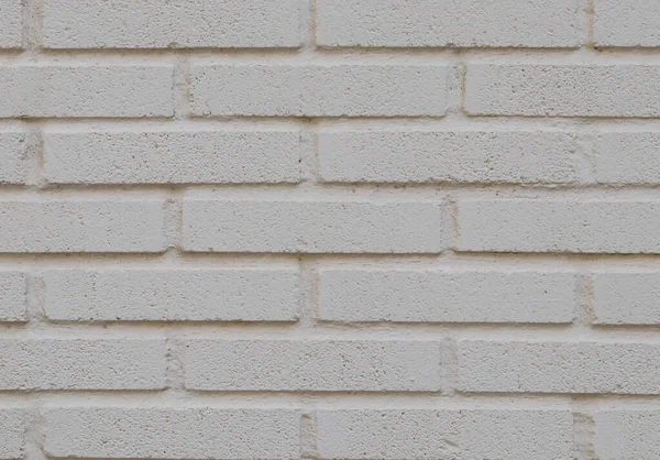 White wall, background, porous brick texture, close-up side view.