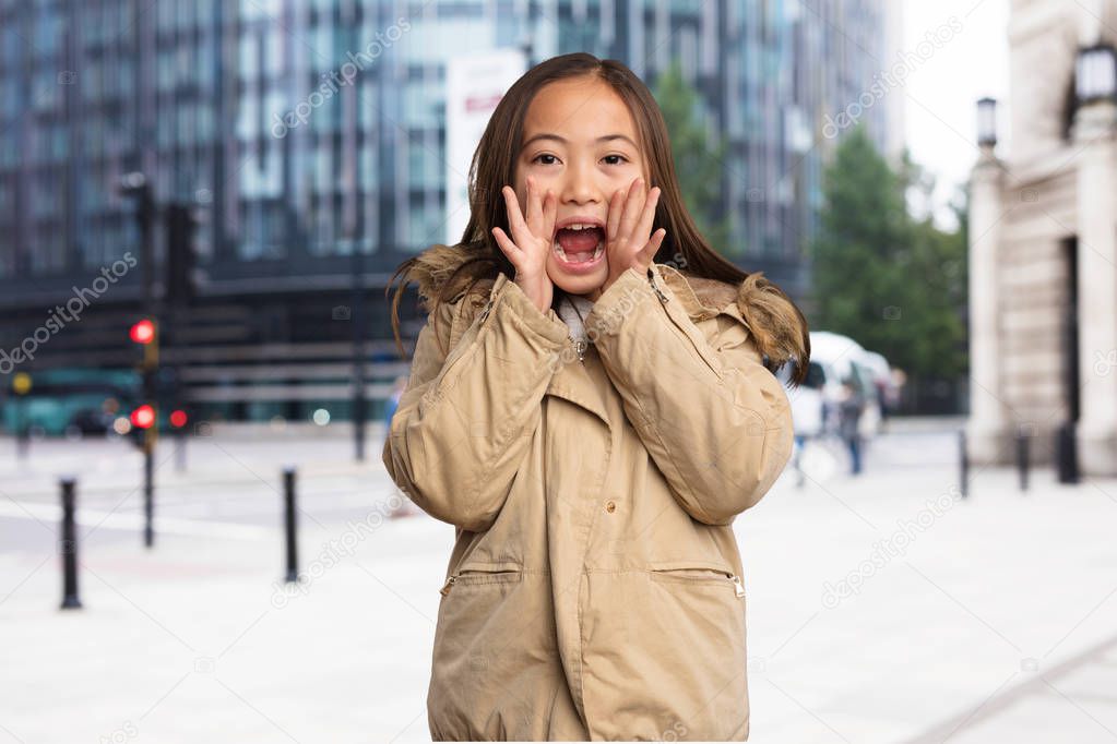 chinese little girl in parka shouting to camera  