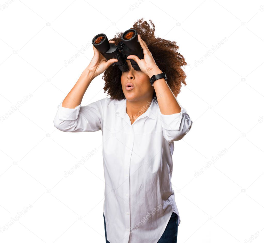 young black woman looking through the binoculars