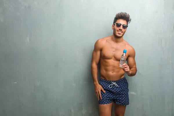 Young Athletic Man Wearing Swimsuit Grunge Wall Cheerful Big Smile — Stock Photo, Image
