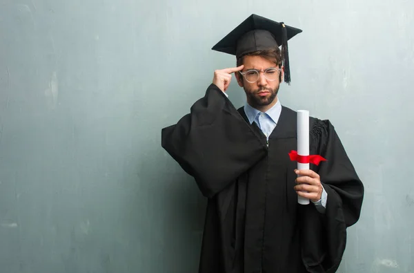 Junger Mann Mit Abschluss Einer Grunge Wand Während Ein Copy — Stockfoto