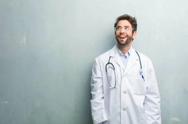 Young Friendly Doctor Man Grunge Wall Copy Space Looking Thinking — Stock Photo, Image