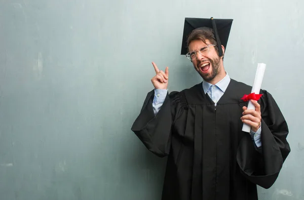 Young Graduated Man Grunge Wall Copy Space Listening Music Dancing — Stock Photo, Image