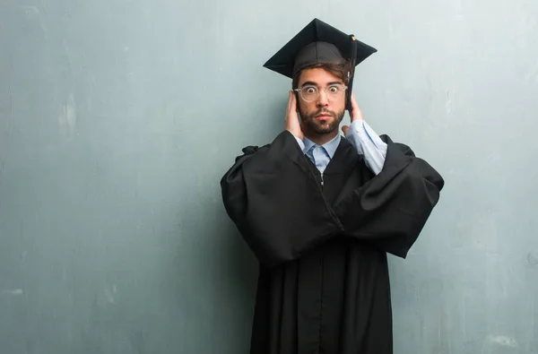 Young Graduated Man Grunge Wall Copy Space Covering Ears Hands — Stock Photo, Image
