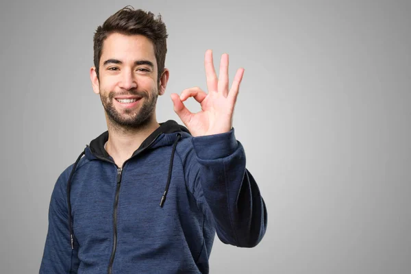 Young Man Doing Okay Gesture Grey Background — Stock Photo, Image