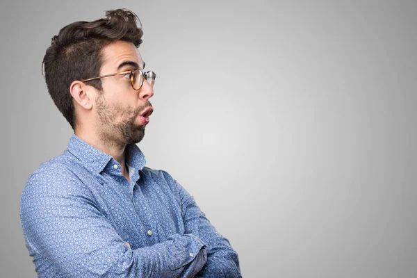 Surprised Young Man Crossing His Arms Grey Background — Stock Photo, Image