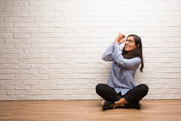 Jonge Indiase Vrouw Zitten Tegen Een Muur Kijken Door Een — Stockfoto