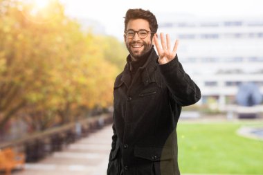 Genç adam numarası dört jest yapıyor