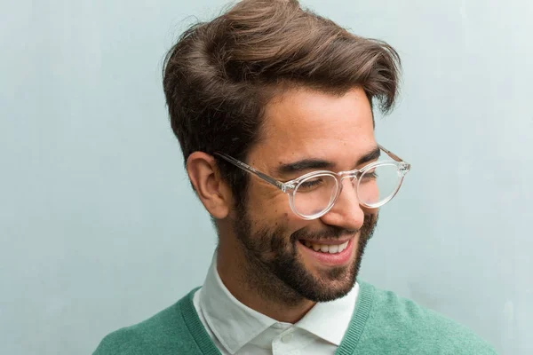 Young handsome entrepreneur man face closeup laughing and having fun, being relaxed and cheerful, feels confident and successful